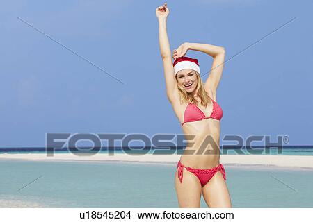Woman Standing On Beach Wearing Santa Hat View Large Photo Image Picture - Woman Standing On Beach Wearing Santa Hat. Fotosearch