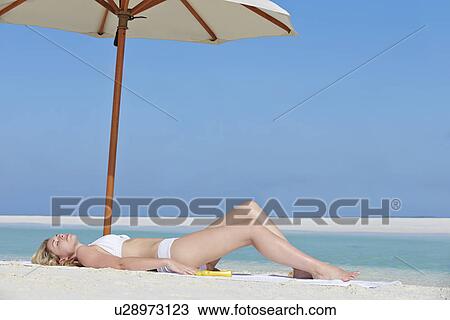 Woman Sunbathing On Beautiful Beach Holiday View Large Photo Image Stock Image - Woman Sunbathing On Beautiful Beach Holiday. Fotosearch