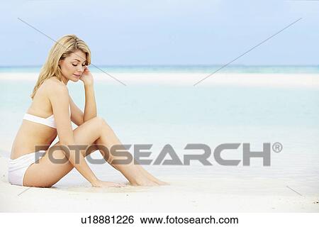 Stock Photograph - Woman Sunbathing On Beautiful Beach Holiday. Fotosearch