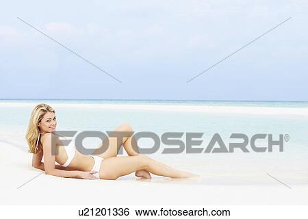 Stock Photograph - Woman Sunbathing On Beautiful Beach Holiday. Fotosearch