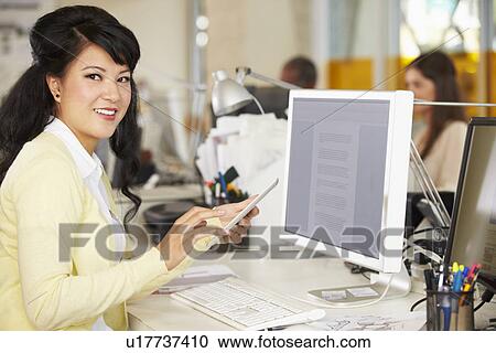 Woman Using Digital Tablet In Busy Creative Office View Large Photo Image Stock Image - Woman Using Digital Tablet In Busy Creative Office. Fotosearch