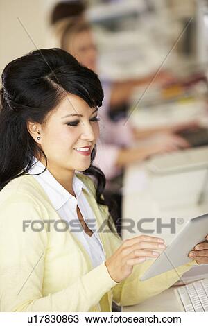 Woman Using Digital Tablet In Busy Creative Office View Large Photo Image Stock Image - Woman Using Digital Tablet In Busy Creative Office. Fotosearch