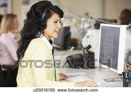 Woman With Headset Working At Desk In Busy Creative Office View Large Photo Image Stock Photography - Woman With Headset Working At Desk In Busy Creative Office. Fotosearch