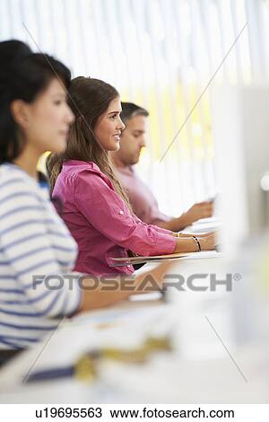 Woman Working At Desk In Busy Creative Office View Large Photo Image Stock Image - Woman Working At Desk In Busy Creative Office. Fotosearch