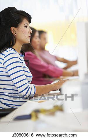Woman Working At Desk In Busy Creative Office View Large Photo Image Stock Photograph - Woman Working At Desk In Busy Creative Office. Fotosearch