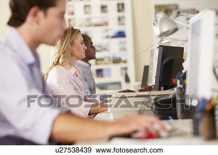 Workers At Desks In Busy Creative Office View Large Photo Image Stock Photo - Workers At Desks In Busy Creative Office. Fotosearch