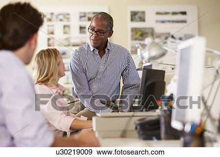Workers At Desks In Busy Creative Office View Large Photo Image Stock Photo - Workers At Desks In Busy Creative Office. Fotosearch