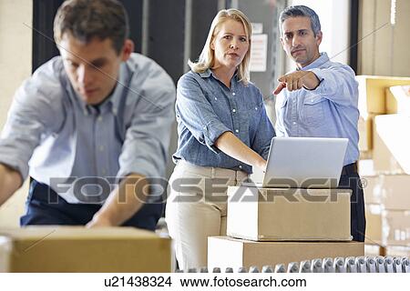 Workers In Distribution Warehouse View Large Photo Image Picture - Workers In Distribution Warehouse. Fotosearch