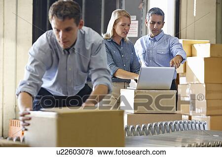 Workers In Distribution Warehouse View Large Photo Image Stock Photo - Workers In Distribution Warehouse. Fotosearch