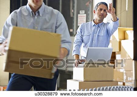 Workers In Distribution Warehouse View Large Photo Image Stock Photo - Workers In Distribution Warehouse. Fotosearch