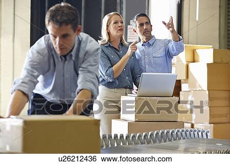 Workers In Distribution Warehouse View Large Photo Image Stock Photograph - Workers In Distribution Warehouse. Fotosearch