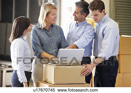 Stock Photography - Workers In Distribution Warehouse. Fotosearch