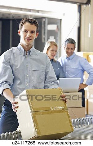 Stock Photography - Workers In Distribution Warehouse. Fotosearch