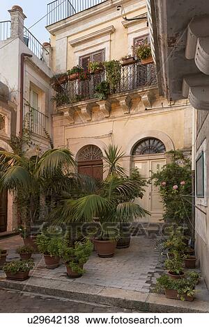 Courtyard in Ragusa Ibla at sunrise, Sicily, Italy View Large Photo Image Stock Photo - Courtyard in Ragusa Ibla at sunrise, Sicily, Italy. Fotosearch