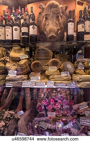 Picture - Delicatessen shop window, traditional salami, cheeses, wines of . Fotosearch
