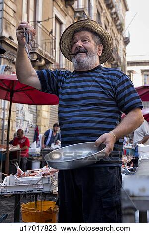 Stock Image - Fish vendor, Catania Fish market, Sicily, Italy. Fotosearch