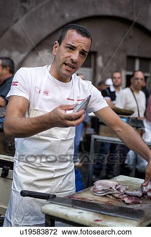 Stock Image - Fish vendor, Catania Fish market, Sicily, Italy. Fotosearch