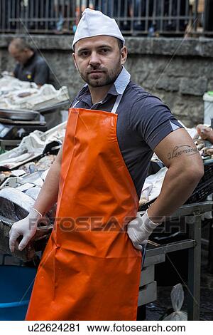 Stock Image - Fish vendor, Catania Fish market, Sicily, Italy. Fotosearch