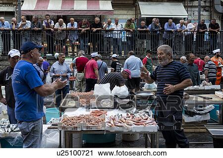 Stock Image - Fish vendor, Catania Fish market, Sicily, Italy. Fotosearch