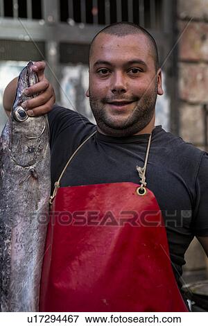 Stock Photo - Fish vendor, Catania Fish market, Sicily, Italy. Fotosearch