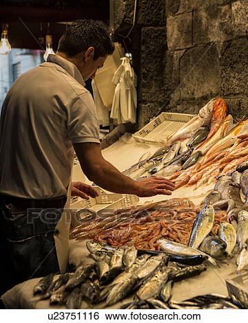 Stock Photograph - Fish vendor, Catania Fish market, Sicily, Italy. Fotosearch