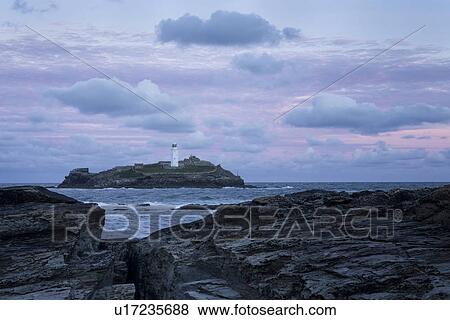 Stock Photo - Godrevey lighthouse at stunning sunrise, Cornwall, England. Fotosearch