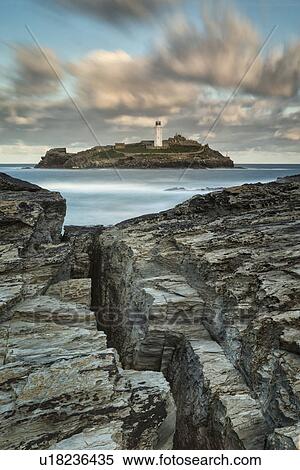 Stock Photography - Godrevey lighthouse at stunning sunrise, Cornwall, England. Fotosearch
