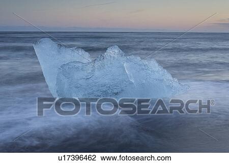Stock Image - Iceberg at Jokulsarlon beach, sunset, Iceland. Fotosearch