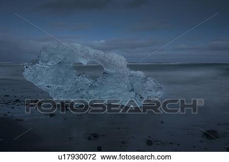 Stock Image - Iceberg at Jokulsarlon beach, sunset, Iceland. Fotosearch