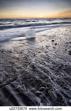 Iceberg on beach at sunrise, Jokulsarlon, Iceland View Large Photo Image Stock Photo - Iceberg on beach at sunrise, Jokulsarlon, Iceland. Fotosearch
