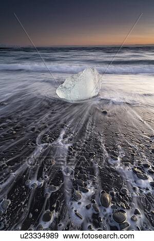 Stock Photo - Iceberg on beach at sunrise, Jokulsarlon, Iceland. Fotosearch