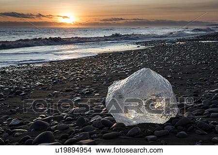 Picture - Iceberg on beach at sunset, Jokulsarlon, Iceland. Fotosearch