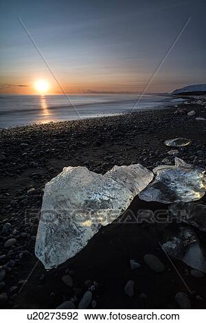 Stock Image - Iceberg on beach at sunset, Jokulsarlon, Iceland. Fotosearch