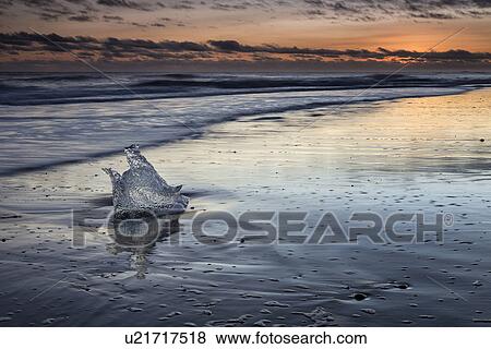 Iceberg on beach at sunset, Jokulsarlon, Iceland View Large Photo Image Stock Photo - Iceberg on beach at sunset, Jokulsarlon, Iceland. Fotosearch