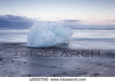 Stock Image - Icebergs at Jokulsarlon beach, sunset, Iceland. Fotosearch