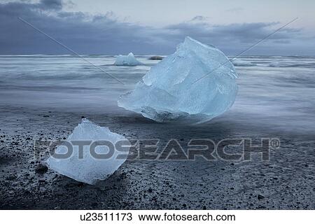 Stock Image - Icebergs at Jokulsarlon beach, sunset, Iceland. Fotosearch
