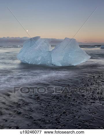 Stock Photo - Icebergs at Jokulsarlon beach, sunset, Iceland. Fotosearch