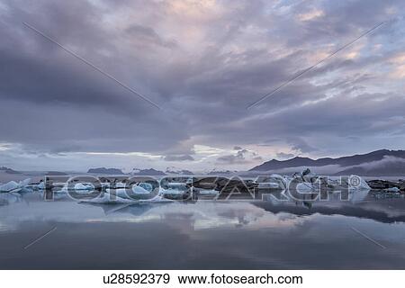 Icebergs at Jokulsarlon lagoon, with glacier, sunrise, Iceland View Large Photo Image Stock Photo - Icebergs at Jokulsarlon lagoon, with glacier, sunrise, Iceland. Fotosearch