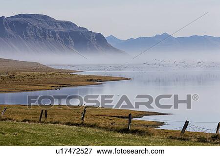 Stock Photo - Iceland coastline in the mist. Fotosearch