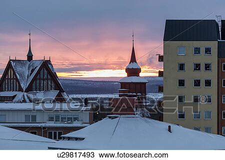 Stock Image - Kiruna city centre snow-covered rooftops at sunrise, Sweden. Fotosearch