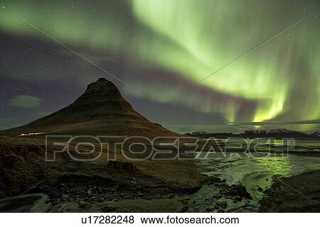 Stock Photo - Northern lights over Kirkjufell mountain, Grundarfjordur, Snaef. Fotosearch