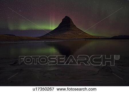Stock Photo - Northern lights over Kirkjufell mountain, Snaefellnes, Iceland. Fotosearch