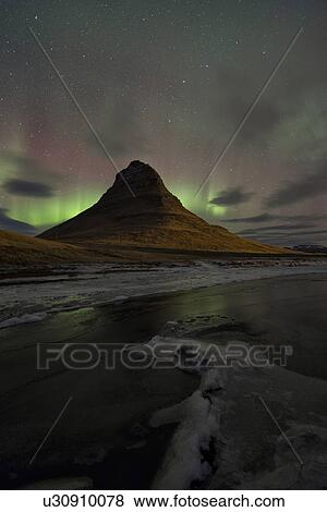 Stock Photo - Northern lights over Kirkjufell mountain, Grundarfjordur, Snaef. Fotosearch