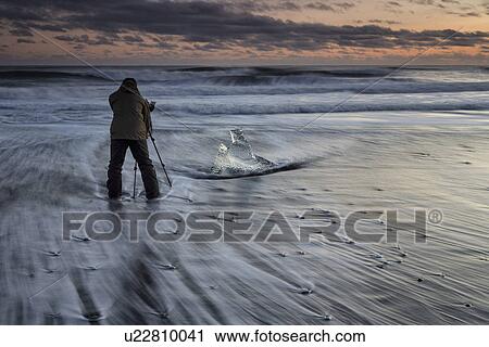 Photographer and iceberg on beach at sunset, Jokulsarlon, Icelan View Large Photo Image Stock Image - Photographer and iceberg on beach at sunset, Jokulsarlon, Icelan. Fotosearch