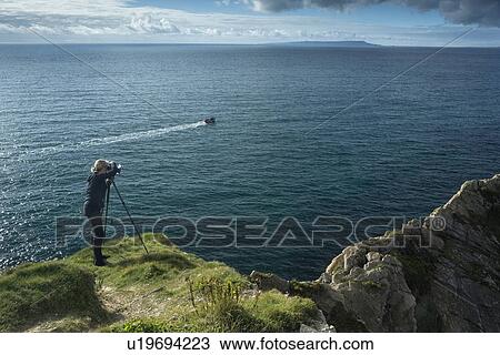 Photographer at Stair Hole cove, Lulworth, Dorset, England View Large Photo Image Stock Image - Photographer at Stair Hole cove, Lulworth, Dorset, England. Fotosearch