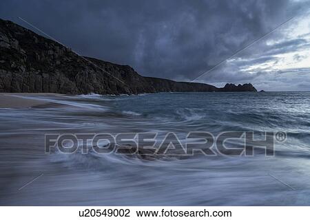 Stock Image - Porthcurno beach at sunrise, Cornwall, England. Fotosearch