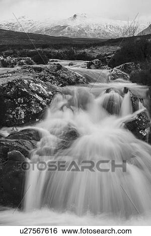 Stock Photograph - River Coupall waterfall with Stob Mhic Mhuin mountain, Buchaille. Fotosearch