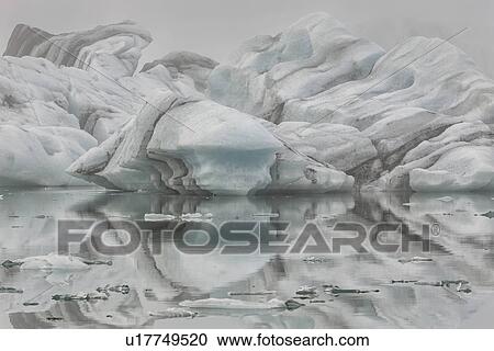 Stock Image - Striped icebergs at Jokulsarlon lagoon, sunrise, Iceland. Fotosearch