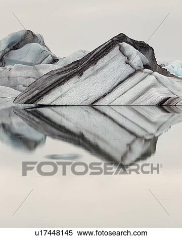 Stock Photography - Striped icebergs at Jokulsarlon lagoon, sunrise, Iceland. Fotosearch