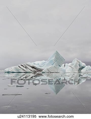 Stock Photography - Striped icebergs at Jokulsarlon lagoon, misty sunrise, Iceland. Fotosearch